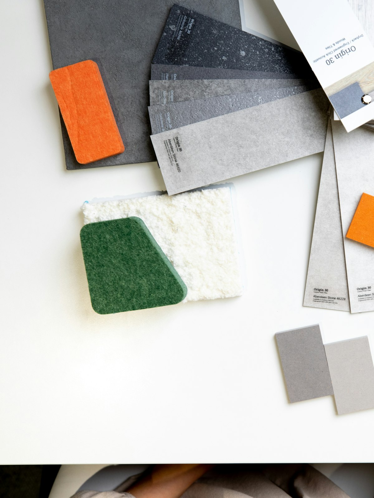 Colour, stone and fabric samples laid out on a white desk